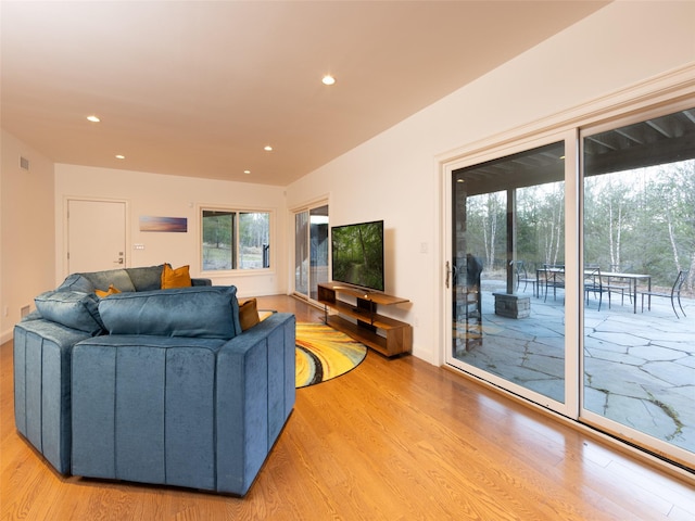 living area with visible vents, recessed lighting, and light wood-style floors