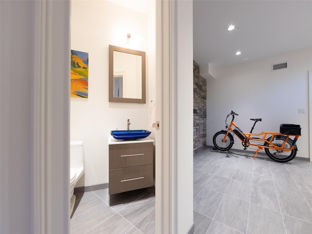 bathroom with visible vents, toilet, recessed lighting, vanity, and tile patterned floors