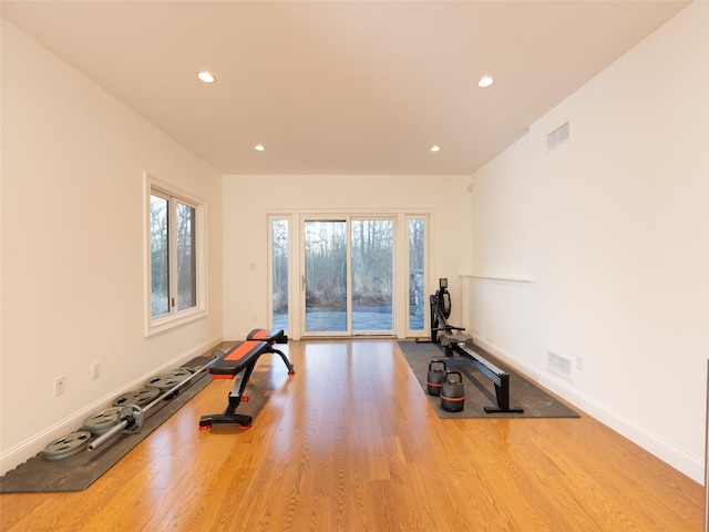 exercise area with recessed lighting, visible vents, baseboards, and wood finished floors