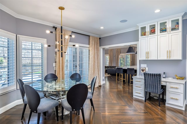 dining room with recessed lighting, built in study area, baseboards, and crown molding