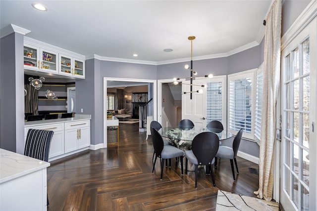 dining room with ornamental molding, baseboards, recessed lighting, and a chandelier