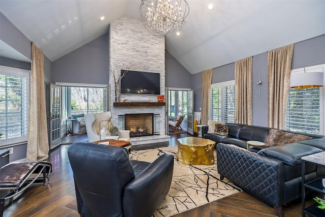living area with high vaulted ceiling, a fireplace, and a wealth of natural light