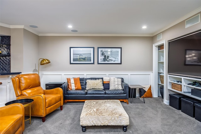 carpeted living area with crown molding, a wainscoted wall, recessed lighting, and a decorative wall