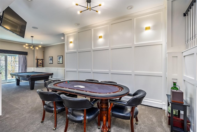 recreation room featuring a decorative wall, carpet flooring, and an inviting chandelier