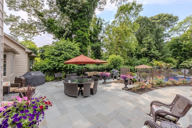 view of patio / terrace featuring grilling area, fence, and outdoor dining area