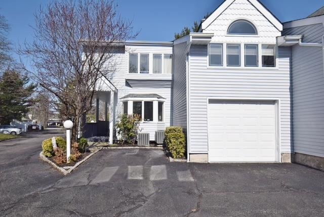 10 Windsor Ct, Amityville, NY 11701 - view of front of house with driveway and central AC