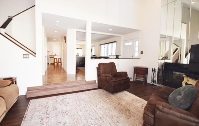 10 Windsor Ct, Amityville, NY 11701 - living area with stairs, a high ceiling, wood finished floors, and recessed lighting