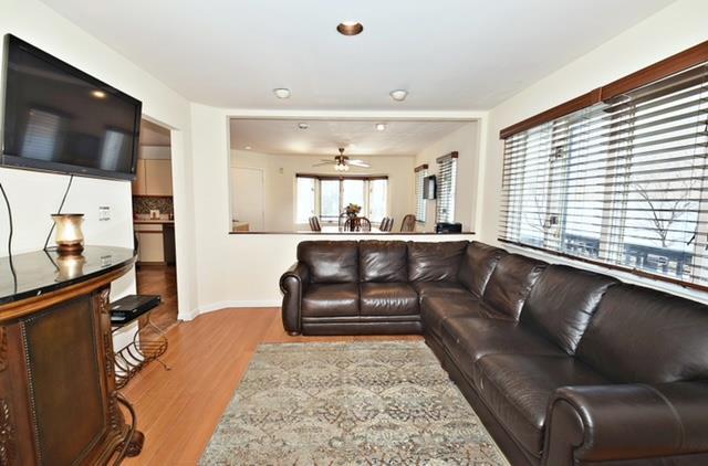 10 Windsor Ct, Amityville, NY 11701 - living area with baseboards, ceiling fan, and wood finished floors