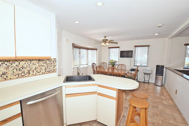 10 Windsor Ct, Amityville, NY 11701 - kitchen with a sink, light countertops, dishwasher, and a peninsula