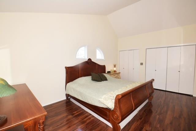 10 Windsor Ct, Amityville, NY 11701 - bedroom with multiple closets, high vaulted ceiling, and wood finished floors