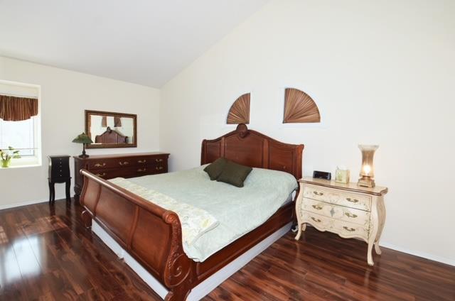 10 Windsor Ct, Amityville, NY 11701 - bedroom featuring lofted ceiling and dark wood-style floors