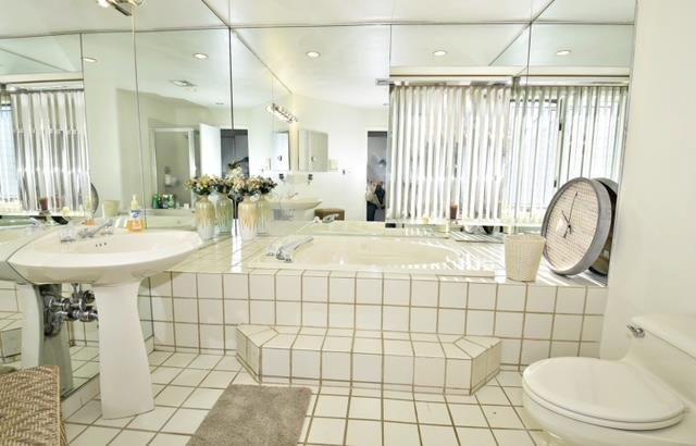 10 Windsor Ct, Amityville, NY 11701 - bathroom with toilet, tile patterned flooring, and a garden tub