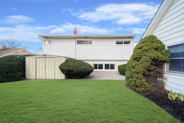 46 Arthur St, Brentwood, NY 11717 - back of house featuring a patio, an outbuilding, a storage shed, and a yard