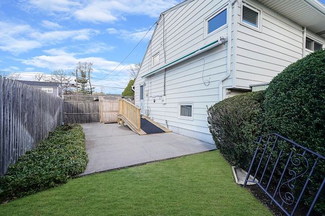 46 Arthur St, Brentwood, NY 11717 - view of property exterior with a fenced backyard, a lawn, and a patio area