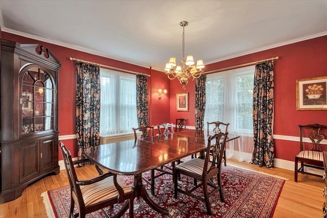 dining area with an inviting chandelier, ornamental molding, and a wealth of natural light