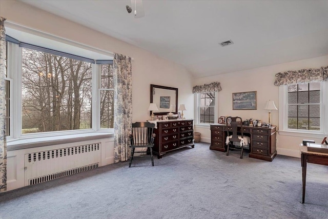living area featuring radiator, carpet, and visible vents