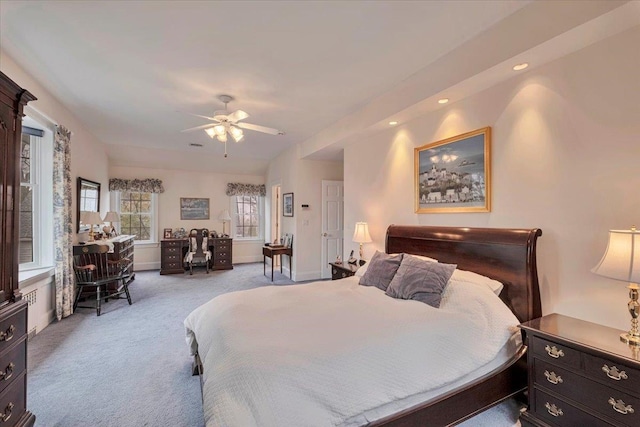 carpeted bedroom with a ceiling fan and recessed lighting