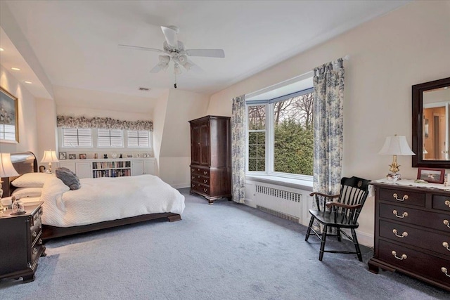 bedroom featuring radiator heating unit, multiple windows, carpet, and visible vents
