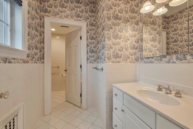 bathroom with wallpapered walls, tile patterned floors, and tile walls