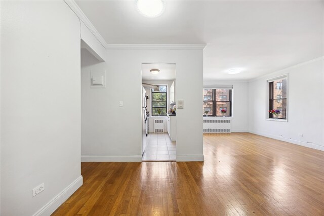 150-10 71st Ave Unit 3L, Flushing, NY 11367 - unfurnished room featuring radiator heating unit, ornamental molding, light wood finished floors, and baseboards