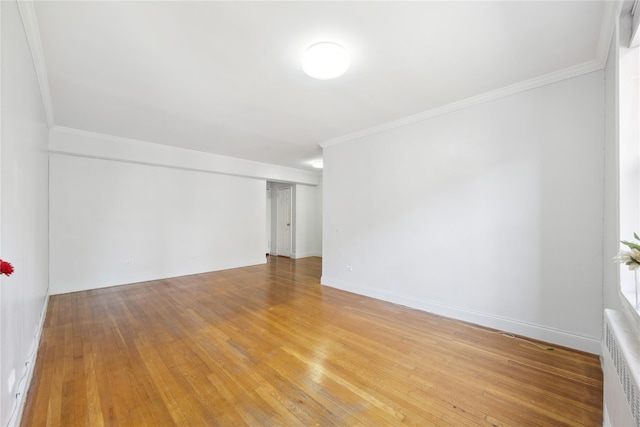 150-10 71st Ave Unit 3L, Flushing, NY 11367 - empty room with radiator heating unit, ornamental molding, light wood finished floors, and baseboards