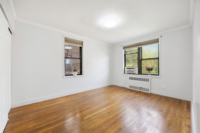 150-10 71st Ave Unit 3L, Flushing, NY 11367 - spare room with radiator, wood-type flooring, crown molding, baseboards, and cooling unit