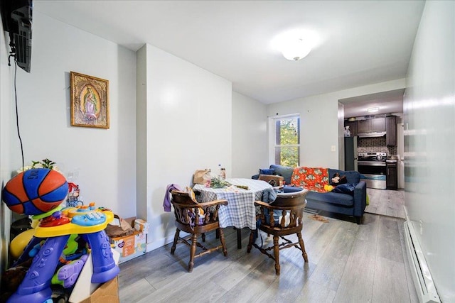 6 Farrington St, Newburgh, NY 12550 - dining room featuring a baseboard heating unit and light wood finished floors