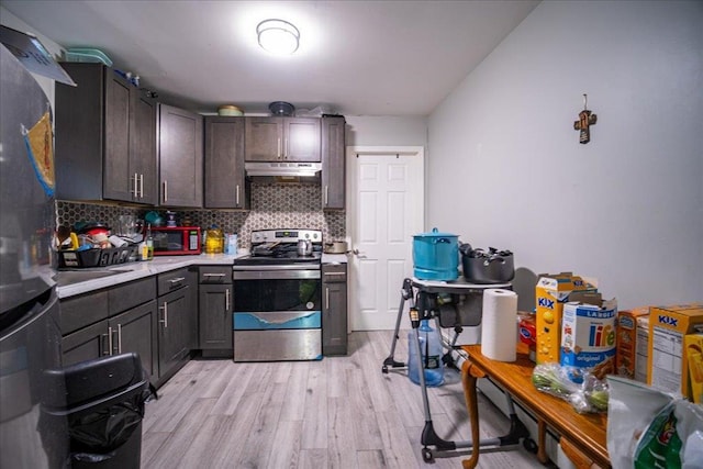 6 Farrington St, Newburgh, NY 12550 - kitchen with light countertops, light wood-style floors, tasteful backsplash, under cabinet range hood, and stainless steel electric stove