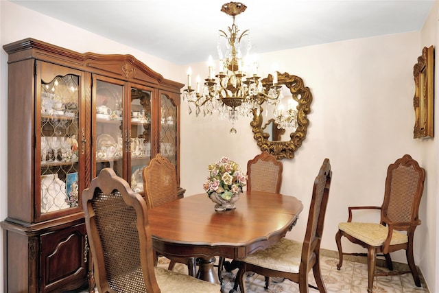 dining area featuring baseboards and a chandelier