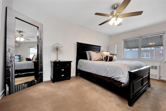 carpeted bedroom with baseboards, ceiling fan, and radiator heating unit