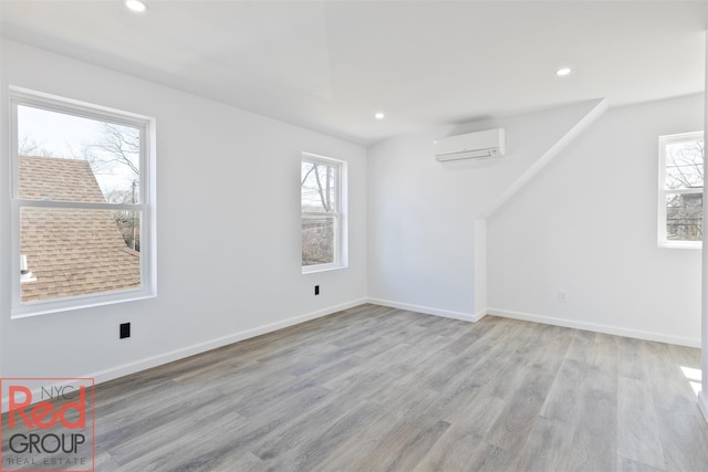 82 Albertson Pl, Mineola, NY 11501 - interior space featuring an AC wall unit, recessed lighting, wood finished floors, and a wealth of natural light