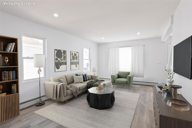 82 Albertson Pl, Mineola, NY 11501 - living room with a healthy amount of sunlight, a baseboard radiator, and light wood finished floors