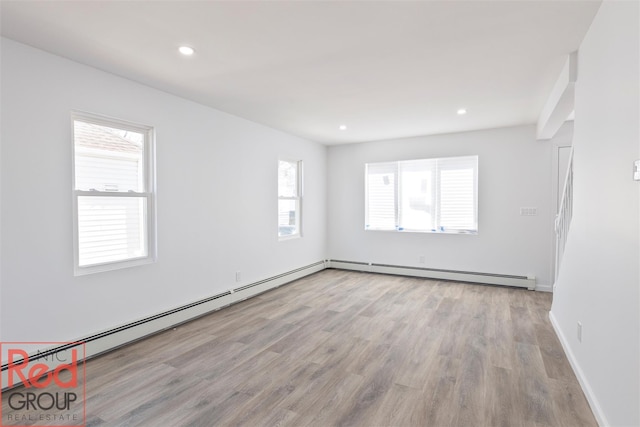 82 Albertson Pl, Mineola, NY 11501 - spare room featuring recessed lighting, baseboards, wood finished floors, and a baseboard radiator