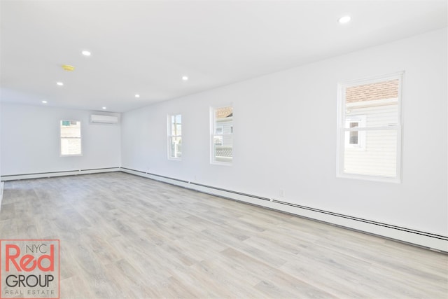 82 Albertson Pl, Mineola, NY 11501 - interior space with an AC wall unit, recessed lighting, wood finished floors, and a healthy amount of sunlight