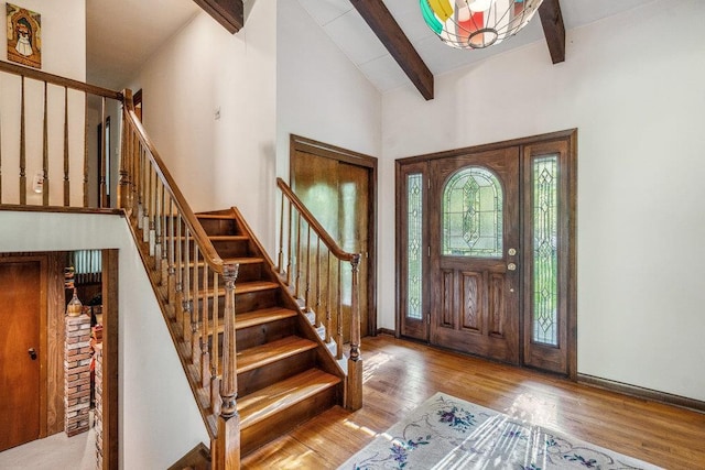 59 Giant Oak Rd, Ridge, NY 11961 - foyer entrance with beam ceiling, wood finished floors, stairs, and high vaulted ceiling