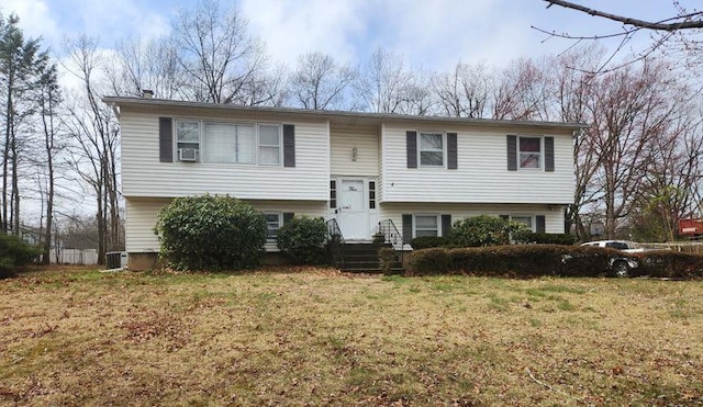 split foyer home featuring central AC and a front lawn