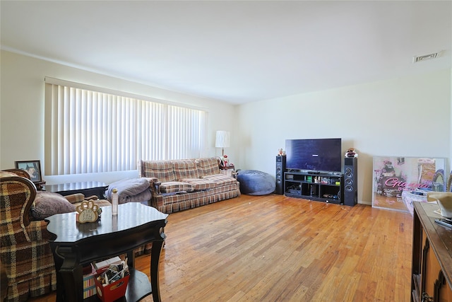 living room featuring light wood finished floors and visible vents