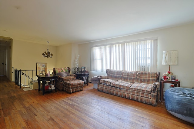 living area with a chandelier and wood finished floors
