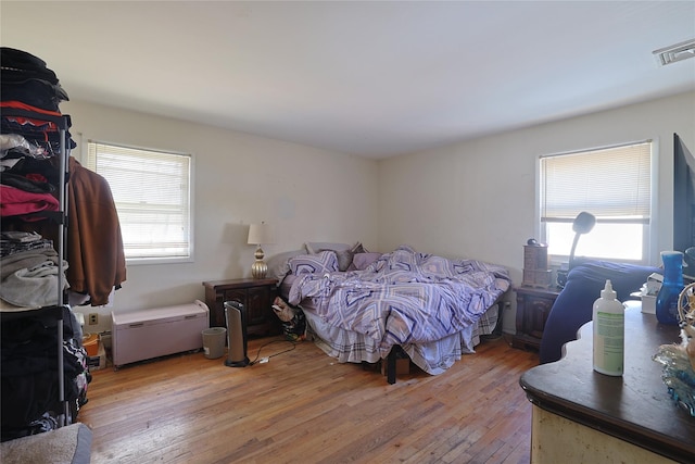 bedroom with visible vents and light wood-style flooring