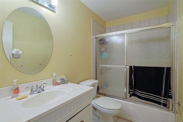 bathroom featuring bath / shower combo with glass door, vanity, and toilet