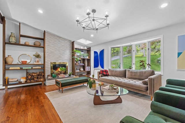 57 Hamilton Dr, Chappaqua, NY 10514 - living area with lofted ceiling, wood finished floors, a chandelier, built in shelves, and recessed lighting