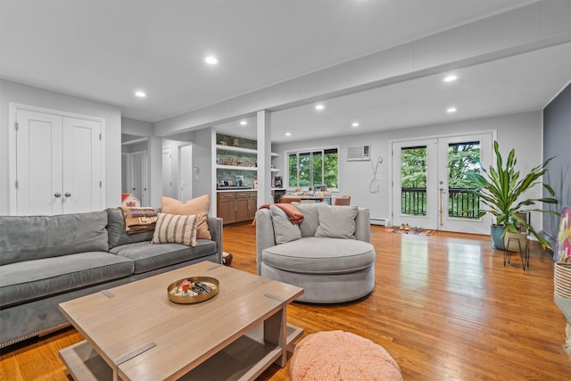 57 Hamilton Dr, Chappaqua, NY 10514 - living area with light wood-style flooring, recessed lighting, a baseboard heating unit, a wall unit AC, and built in shelves