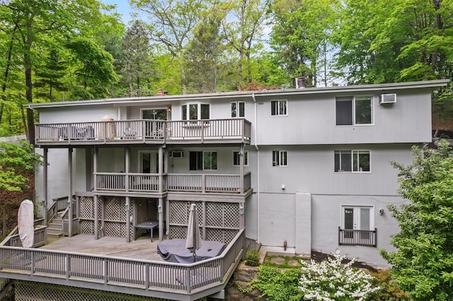 57 Hamilton Dr, Chappaqua, NY 10514 - rear view of house featuring a deck, view of wooded area, and a wall mounted AC