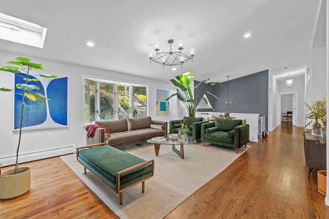 57 Hamilton Dr, Chappaqua, NY 10514 - living area featuring a baseboard radiator, a chandelier, wood finished floors, recessed lighting, and a skylight
