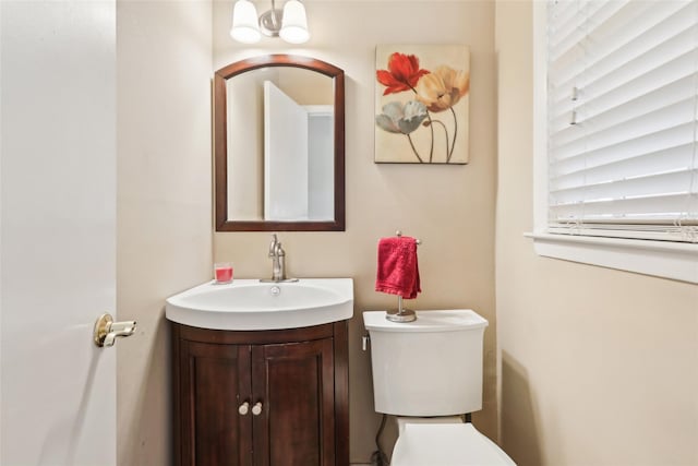 bathroom with toilet and vanity