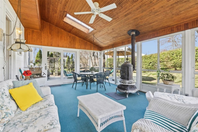sunroom / solarium featuring wood ceiling, outdoor lounge area, carpet, a ceiling fan, and high vaulted ceiling