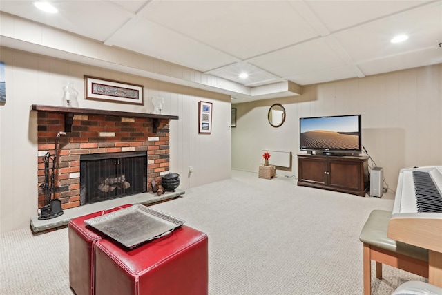 living area with recessed lighting, carpet, and a fireplace
