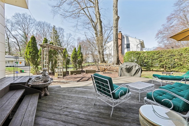 wooden deck featuring an outdoor hangout area and area for grilling