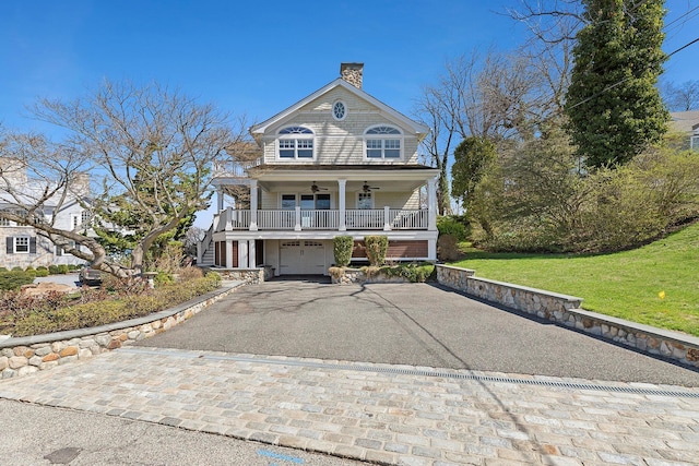 356 Bay Ave, Huntington Bay, NY 11743 - view of front of property featuring ceiling fan, aphalt driveway, a porch, stairs, and a chimney