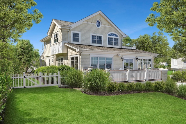 356 Bay Ave, Huntington Bay, NY 11743 - rear view of house featuring fence, a lawn, and a gate